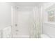 Clean bathroom with a white shower/tub combo and a decorative shower curtain at 1050 Hagley Dr., Pawleys Island, SC 29585