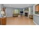 Spacious living room with a fireplace, wood floors, and large windows offering lots of natural light at 1050 Hagley Dr., Pawleys Island, SC 29585
