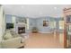 Bright living room features a cozy fireplace, wood floors, and views into the dining room at 1050 Hagley Dr., Pawleys Island, SC 29585