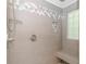 Modern tiled shower with rainfall shower head, built-in niche, and bench for a spa-like experience at 1050 Hagley Dr., Pawleys Island, SC 29585