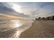 Scenic view of a sandy beach with gentle waves meeting the shore, condo buildings in the distance at 1058 Sea Mountain Hwy. # 4-203, North Myrtle Beach, SC 29582