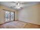 Spacious bedroom with a ceiling fan and access to a balcony through sliding glass doors, offering natural light at 1058 Sea Mountain Hwy. # 4-203, North Myrtle Beach, SC 29582
