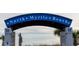 Welcoming entrance to North Myrtle Beach with a blue archway and palm trees, under a bright sky at 1058 Sea Mountain Hwy. # 4-203, North Myrtle Beach, SC 29582