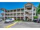 Spacious multi-story condo complex with charming balconies and ample parking on a beautiful day at 1058 Sea Mountain Hwy. # 4-203, North Myrtle Beach, SC 29582