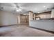 Spacious living room with a kitchen area, neutral paint and carpet, and a ceiling fan at 1058 Sea Mountain Hwy. # 4-203, North Myrtle Beach, SC 29582