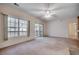 Bright and airy living room with windows, sliding glass doors to the balcony, and neutral carpet at 1058 Sea Mountain Hwy. # 4-203, North Myrtle Beach, SC 29582