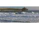 Crashing waves at the pier with wooden support beams and observation deck at 1058 Sea Mountain Hwy. # 4-203, North Myrtle Beach, SC 29582