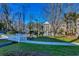Picturesque view of a pond with a white bridge and condo buildings nestled among lush trees at 1058 Sea Mountain Hwy. # 4-203, North Myrtle Beach, SC 29582