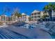 Community pool surrounded by lounge chairs and condo buildings with screened-in porches at 1058 Sea Mountain Hwy. # 4-203, North Myrtle Beach, SC 29582