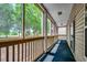 Inviting screened porch with wood railings and a view of lush greenery at 1058 Sea Mountain Hwy. # 4-203, North Myrtle Beach, SC 29582