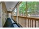 Relaxing screened porch featuring wood railings and exterior building access at 1058 Sea Mountain Hwy. # 4-203, North Myrtle Beach, SC 29582