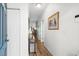 Hallway with wood-look flooring, white walls and doors, and hall table with lamp at 1058 Sea Mountain Hwy. # 9-101, North Myrtle Beach, SC 29582