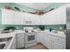 Kitchen featuring white cabinets, ample counter space, a microwave, oven, and coffee maker at 1058 Sea Mountain Hwy. # 9-101, North Myrtle Beach, SC 29582