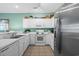 Kitchen featuring white cabinets, ample counter space, stainless steel refrigerator and tile floors at 1058 Sea Mountain Hwy. # 9-101, North Myrtle Beach, SC 29582