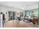 Bright living room with wood-look floors, ceiling fan, and sliding glass doors to a screened-in porch at 1058 Sea Mountain Hwy. # 9-101, North Myrtle Beach, SC 29582
