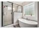 Bright bathroom featuring a standalone tub and glass enclosed shower at 109 Obd Way, Myrtle Beach, SC 29588