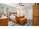 Well-lit bedroom featuring a decorative bed, a ceiling fan, and an ornate wooden chest at 109 Obd Way, Myrtle Beach, SC 29588