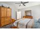 Bright bedroom with wood furnishings, ceiling fan, and a comfortable bed with patterned bedding at 109 Obd Way, Myrtle Beach, SC 29588