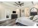 Bedroom with tray ceiling and fan, wood look flooring, decorative furniture and exterior door access at 109 Obd Way, Myrtle Beach, SC 29588