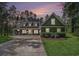 Exterior view of the home showcasing a long driveway, well-manicured lawn, and mature trees at 109 Obd Way, Myrtle Beach, SC 29588