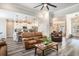 Open concept living room with kitchen and dining areas and comfortable leather furniture at 109 Obd Way, Myrtle Beach, SC 29588