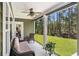 Covered patio with seating area and fan, overlooking a grassy yard and trees at 109 Obd Way, Myrtle Beach, SC 29588