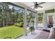 Screened-in patio with furniture, overlooking a backyard with a pool and pond at 109 Obd Way, Myrtle Beach, SC 29588