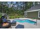 Backyard pool area with seating, barbecue grill, and fire pit at 109 Obd Way, Myrtle Beach, SC 29588