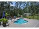 Outdoor pool area featuring a kidney-shaped pool, patio furniture, barbecue, and shed in a private, wooded backyard at 109 Obd Way, Myrtle Beach, SC 29588