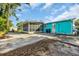 A bright aqua-colored home with a screened in porch and a large concrete patio at 1107 Blue Ridge Trail, North Myrtle Beach, SC 29582