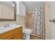 Bathroom featuring vanity with cabinet and shower with seashell themed curtain at 1107 Blue Ridge Trail, North Myrtle Beach, SC 29582