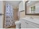 Bathroom with vanity and cabinet and shower with seashell themed curtain at 1107 Blue Ridge Trail, North Myrtle Beach, SC 29582