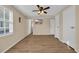 Bright bedroom with wood-look flooring, ceiling fan, and mounted flat screen TV at 1107 Blue Ridge Trail, North Myrtle Beach, SC 29582