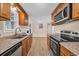 Well-lit kitchen featuring stainless steel appliances, wooden cabinets, and light countertops at 1107 Blue Ridge Trail, North Myrtle Beach, SC 29582