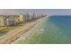 Aerial view of a sun-soaked beach, city skyline, and inviting shoreline at 1127 Pine Dr., Myrtle Beach, SC 29577