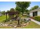Inviting backyard oasis with a pergola, lush landscaping, and stone edging at 1127 Pine Dr., Myrtle Beach, SC 29577