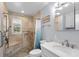 Updated bathroom featuring tiled shower with bench, grab bars, and white vanity at 1127 Pine Dr., Myrtle Beach, SC 29577