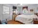 Sunlit bedroom featuring hardwood floors, TV and a window with backyard view at 1127 Pine Dr., Myrtle Beach, SC 29577