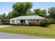 Charming one-story home with brick accents, a well-manicured lawn, and mature landscaping at 1127 Pine Dr., Myrtle Beach, SC 29577
