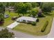 Beautiful single-story home featuring a well-manicured lawn, mature trees, and a concrete driveway at 1127 Pine Dr., Myrtle Beach, SC 29577