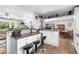 Bright kitchen featuring white cabinetry, bar-style seating, and view into the adjacent dining area at 1127 Pine Dr., Myrtle Beach, SC 29577