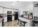 Well-lit kitchen with white cabinets, bar seating, and modern appliances at 1127 Pine Dr., Myrtle Beach, SC 29577