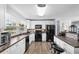 Modern kitchen with white cabinets, stainless steel appliances, and a breakfast bar at 1127 Pine Dr., Myrtle Beach, SC 29577