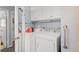 Bright laundry room featuring white cabinets and modern washer and dryer at 1127 Pine Dr., Myrtle Beach, SC 29577