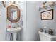 Charming powder room with pedestal sink, decorative mirror, and classic fixtures at 1127 Pine Dr., Myrtle Beach, SC 29577