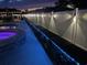 Backyard pool area featuring a privacy fence with accent lighting and patio furniture at 113 Adelphia Rd., Loris, SC 29569