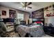 This bedroom features a ceiling fan, a bed with patterned covers and a study area with a computer setup at 113 Adelphia Rd., Loris, SC 29569