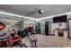 The bonus room features a large screen TV, refrigerator, instruments, and a garage door at 113 Adelphia Rd., Loris, SC 29569