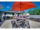 Outdoor dining area with large umbrella, providing a shaded space for Gathering gatherings and summer meals at 113 Adelphia Rd., Loris, SC 29569