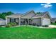 Charming single-story home featuring lush green lawn, landscaping, and inviting front porch with rocking chairs at 113 Adelphia Rd., Loris, SC 29569